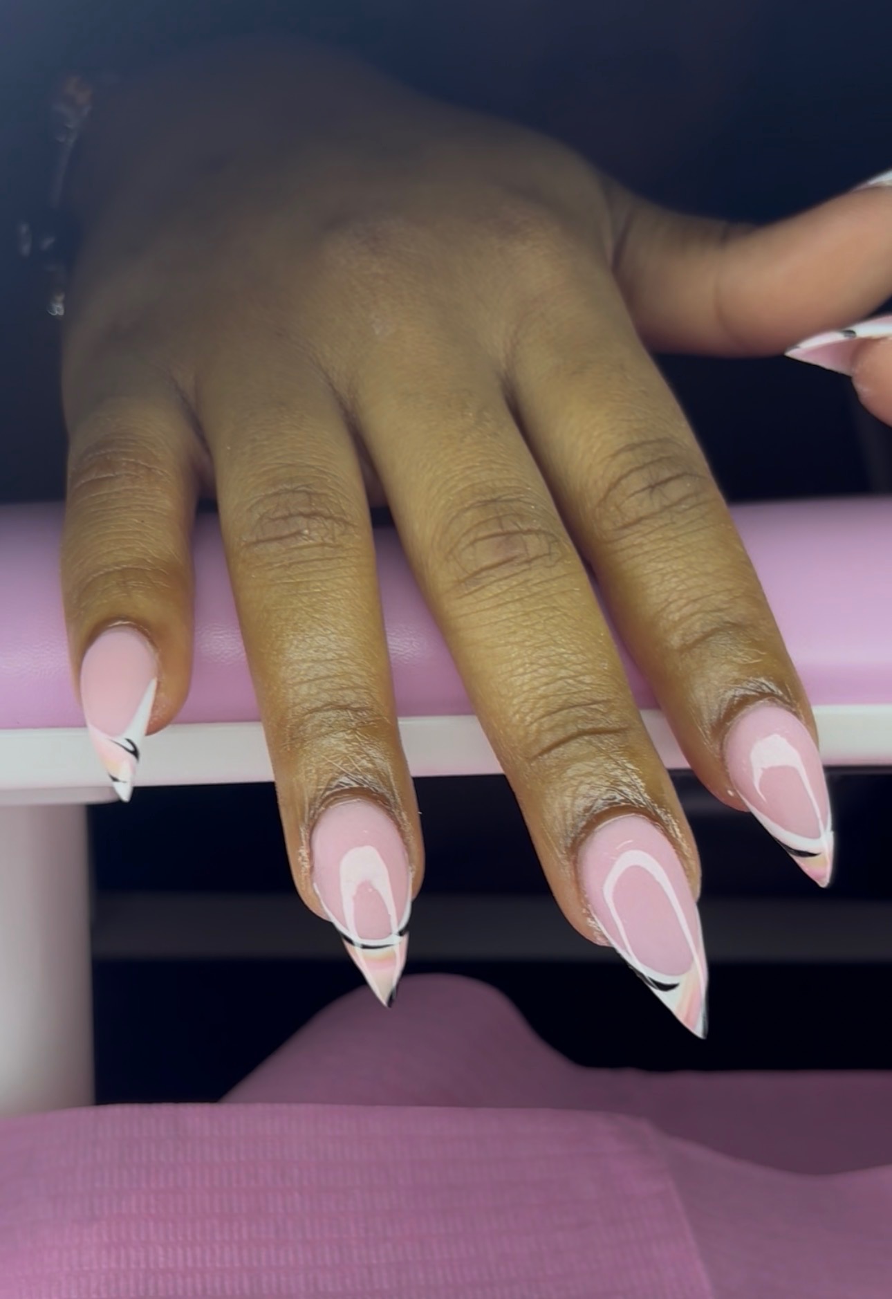 Pink nail art with white and black accents